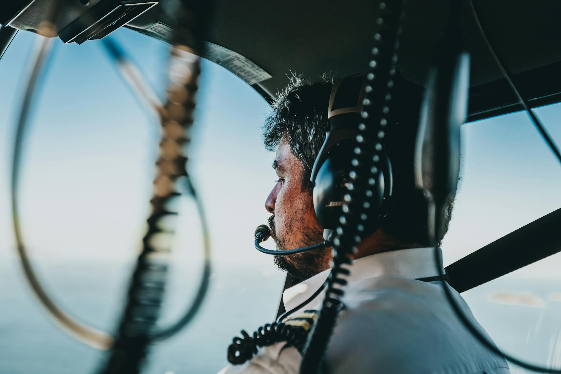 photo of man flying a helicopter