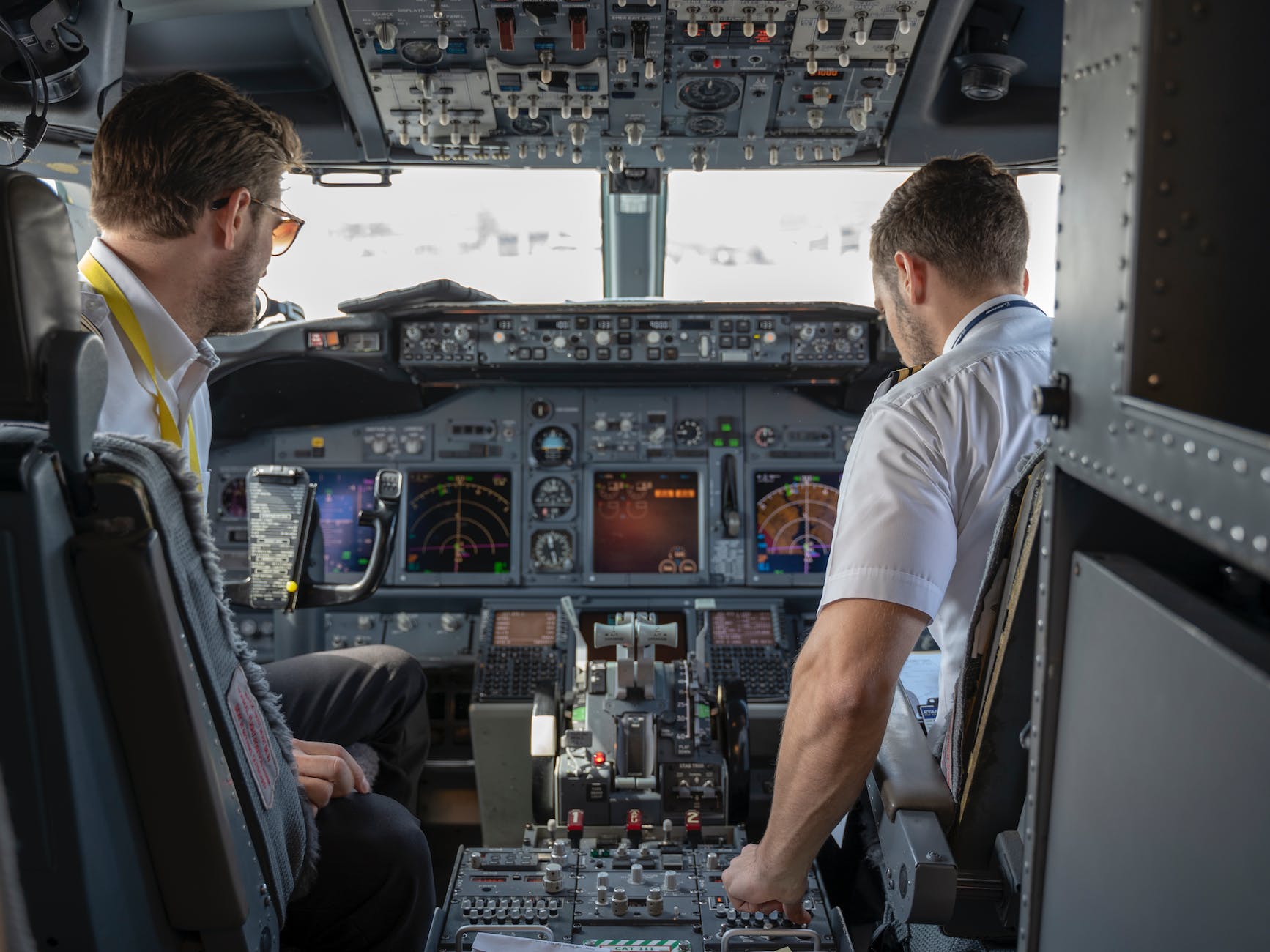 two pilots sitting inside plane